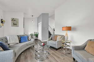 Living area featuring wood finished floors and a high ceiling