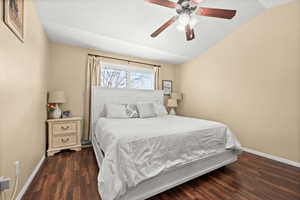 Bedroom featuring lofted ceiling, dark wood finished floors, and ceiling fan
