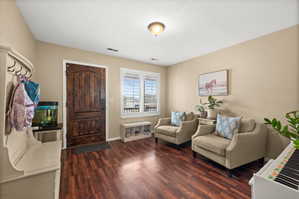 Living area featuring dark wood-style floors and a textured ceiling