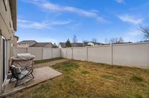 Fenced backyard with a patio and a residential view