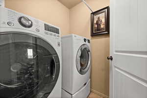 Laundry room with washer and clothes dryer