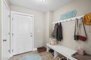 Mudroom with light tile patterned floors