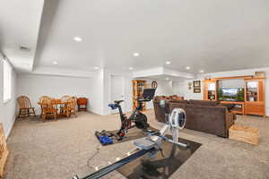Workout area with light carpet, a textured ceiling, and recessed lighting