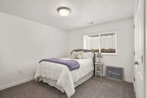 Bedroom with baseboards and carpet