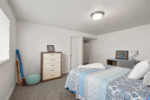 Carpeted bedroom featuring baseboards