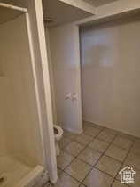 Full bathroom with a shower stall and light tile patterned flooring