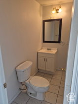 Half bathroom with vanity and light tile patterned floors