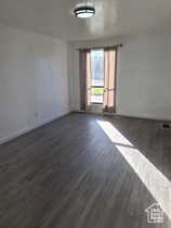 Empty room with dark wood-style floors