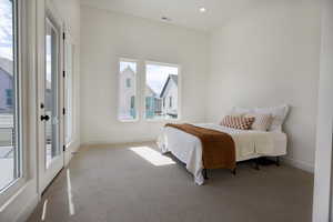 Primary bedroom with access to balcony and 12ft ceilings