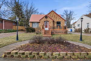View of front of home with brick siding and a deck