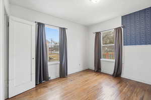 Spare room with light wood-style flooring and baseboards