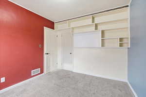 Unfurnished bedroom with carpet flooring and a closet