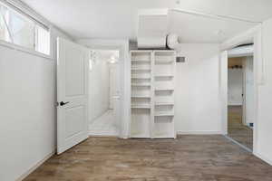 Unfurnished bedroom with light wood-style floors and baseboards