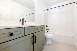Modern bath featuring a sage green vanity with matte black hardware, white countertop, and a sleek black faucet