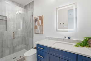 Bathroom featuring a stall shower and vanity