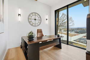Office space with light wood finished floors and baseboards