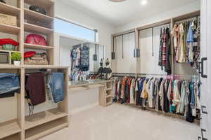 Walk in closet with carpet flooring