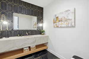 Bathroom featuring vanity and baseboards