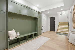 Mudroom with light wood finished floors and recessed lighting