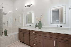 Bathroom with double vanity and a stall shower