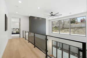Corridor featuring light wood-style flooring and recessed lighting