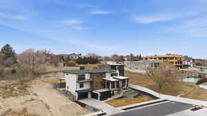 View of front of house featuring a residential view, a garage, driveway, and a balcony