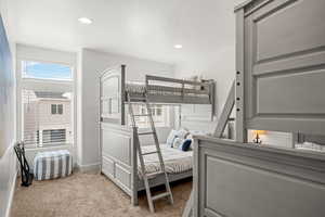 Bedroom with light colored carpet, a textured ceiling, and recessed lighting