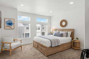Carpeted bedroom with recessed lighting