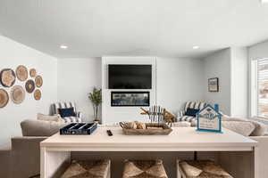 Living room with recessed lighting and a textured ceiling