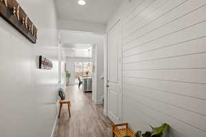 Hallway with recessed lighting and light wood-style floors