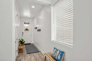 Foyer entrance featuring light wood finished floors and recessed lighting
