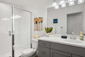 Bathroom with a stall shower and vanity