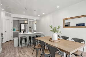 Dining area featuring light wood finished floors and recessed lighting