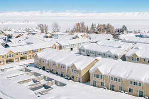 Snowy aerial view featuring a residential view