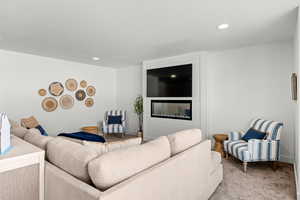 Living area with carpet flooring and baseboards