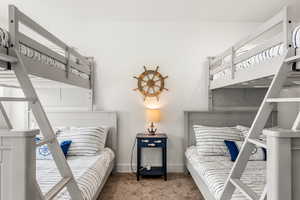 Bedroom with carpet flooring and baseboards