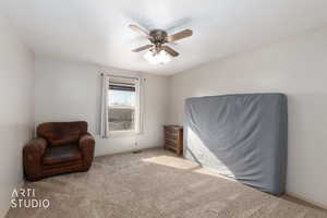Sitting room featuring carpet floors and ceiling fan