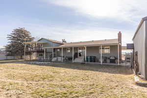 Rear view of property featuring a patio area, roof with shingles, and entry steps