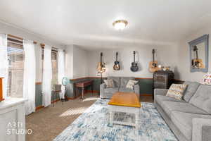 Carpeted living room featuring baseboards