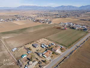 Aerial view of property's location featuring rural landscape, mountains, and nearby suburban area