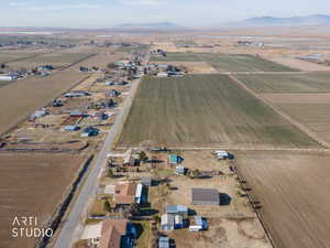 Aerial view of property's location with rural landscape, mountains, and large plots for crops