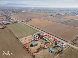 Overview of rural landscape with property parcel outlined and mountains