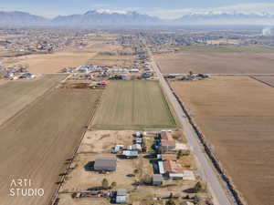 Aerial overview of property's location featuring rural landscape, mountains, and nearby suburban area
