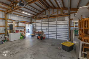 Garage featuring a garage door opener and metal wall