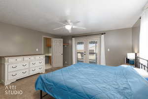 Bedroom featuring french doors, carpet flooring, a ceiling fan, access to exterior, and a textured ceiling