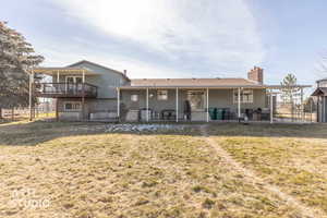Back of house with a patio, a chimney, and a wooden deck