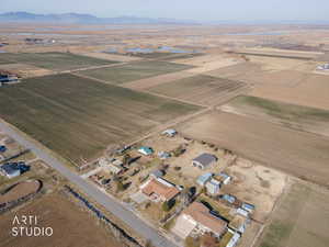 Aerial view of property and surrounding area featuring rural landscape and large plots for crops