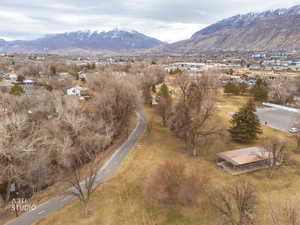 Drone / aerial view of the park, river trail and majestic mountain backdrop