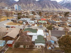 Aerial view of residential area featuring mountains and city view.