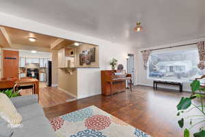 Living area featuring light wood finished floors and baseboards